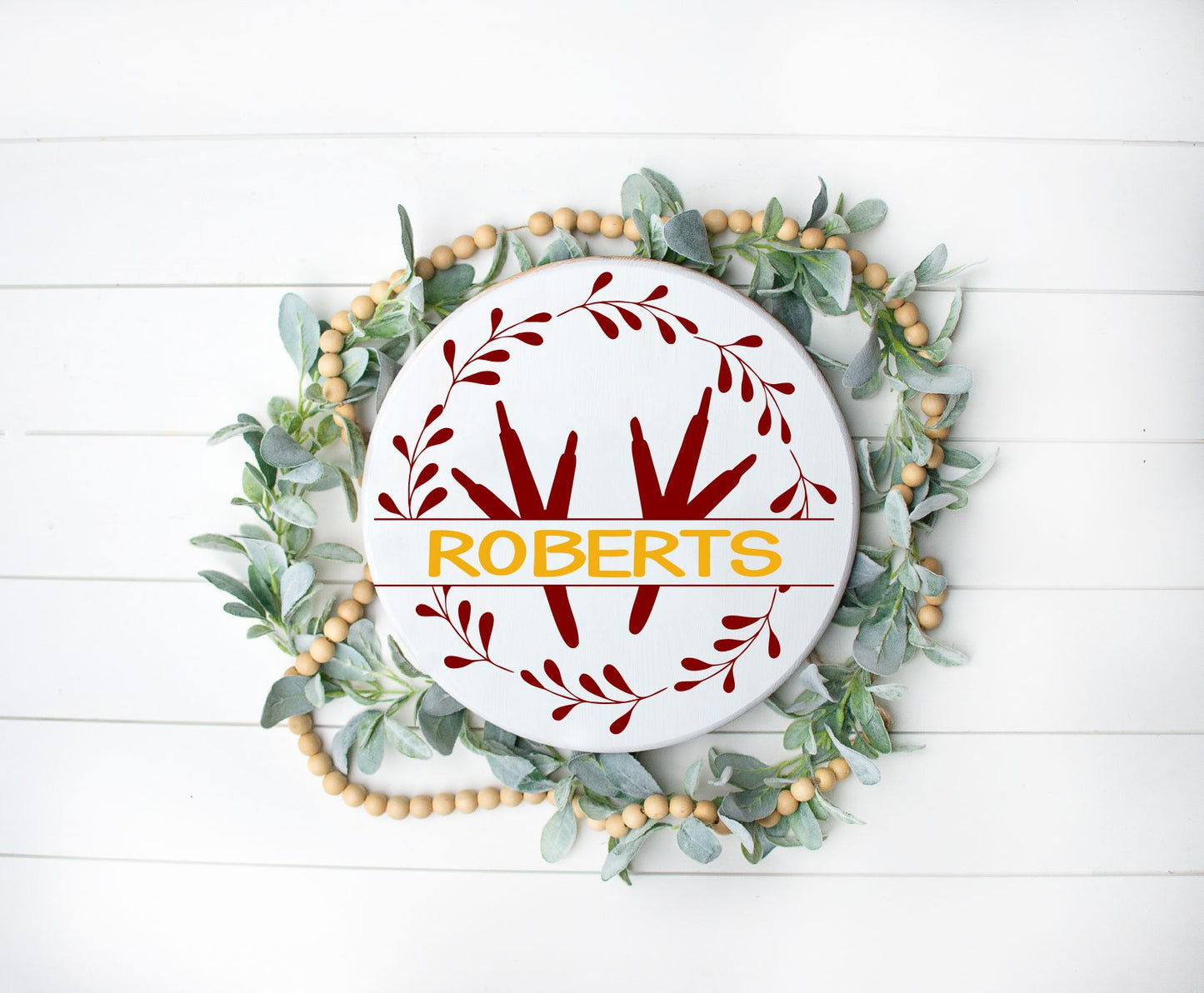 round or doorhanger with chicken feet surrounded by a wreath with a last name